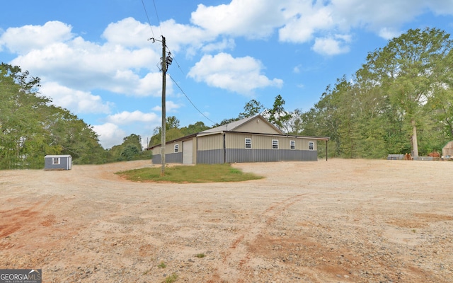 view of side of home with a storage unit