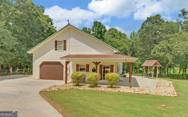 farmhouse with covered porch, a garage, and a front lawn