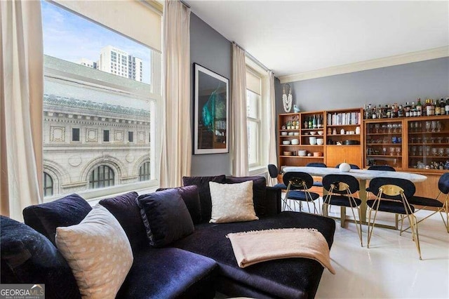 living room featuring ornamental molding, a wealth of natural light, and indoor bar