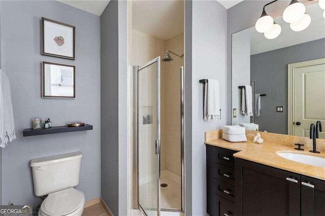 bathroom featuring walk in shower, vanity, and toilet