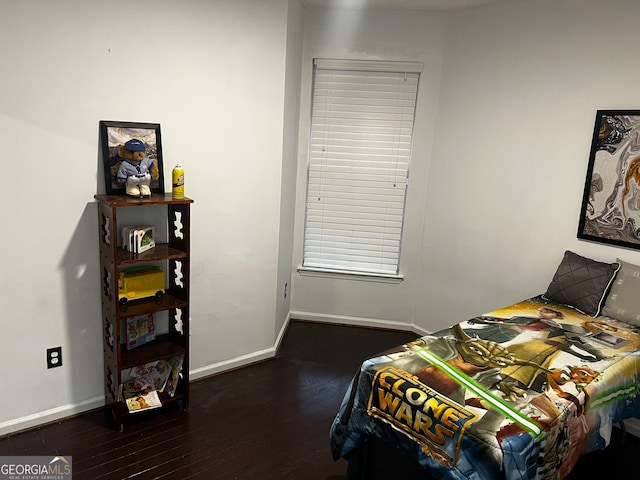 bedroom with dark wood-type flooring