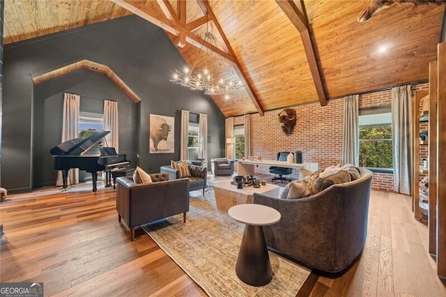 living room with an inviting chandelier, hardwood / wood-style flooring, and lofted ceiling with beams