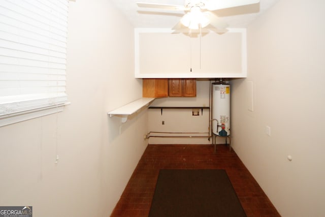 laundry area featuring gas water heater and ceiling fan