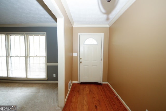 doorway to outside featuring crown molding