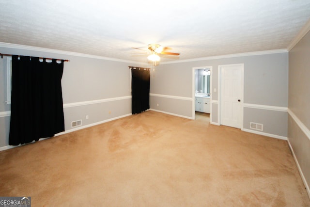 carpeted spare room with ornamental molding and ceiling fan