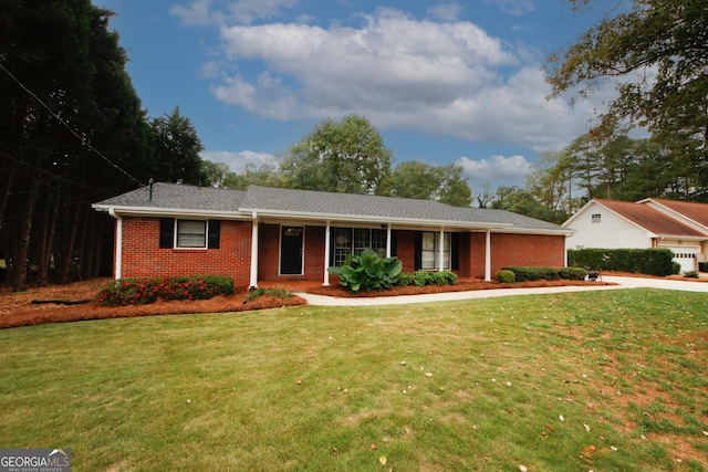 single story home with a front lawn and brick siding