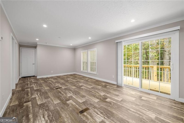 empty room featuring crown molding and dark hardwood / wood-style flooring