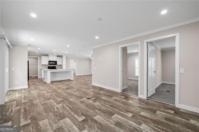 unfurnished living room featuring light wood-type flooring and ornamental molding