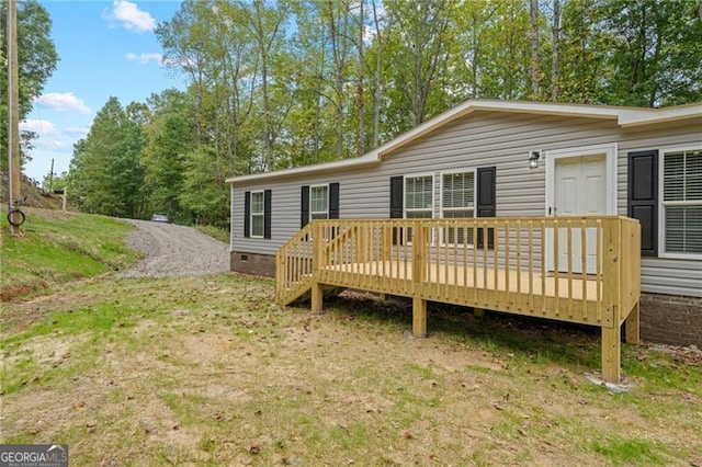 rear view of property featuring a wooden deck