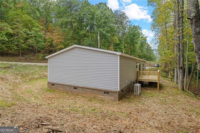 view of side of property featuring central AC and a wooden deck