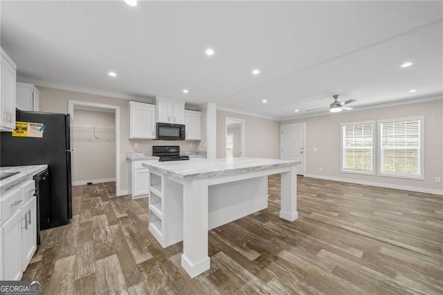 kitchen featuring white cabinetry, a kitchen island, light wood-type flooring, black appliances, and ceiling fan