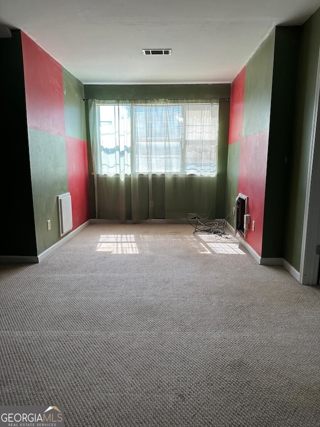 unfurnished room featuring light carpet