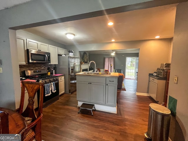 kitchen with white cabinetry, dark wood-type flooring, and stainless steel appliances