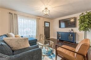 living room with hardwood / wood-style floors and a chandelier