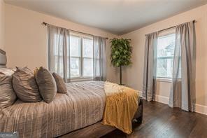 bedroom with dark wood-type flooring