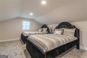 bedroom featuring vaulted ceiling and light colored carpet