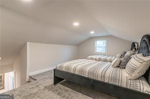 carpeted bedroom with vaulted ceiling