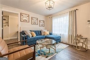 living room featuring an inviting chandelier and hardwood / wood-style flooring