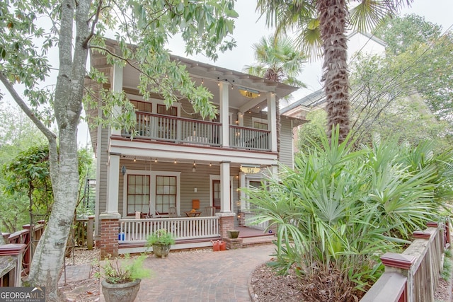 view of front of property with a balcony and covered porch