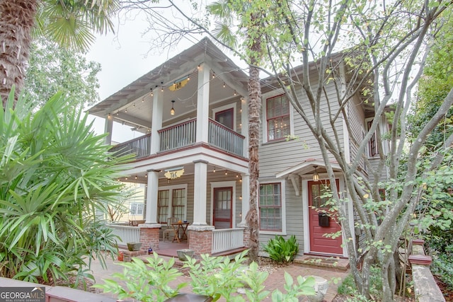 view of front facade with a balcony and a patio area