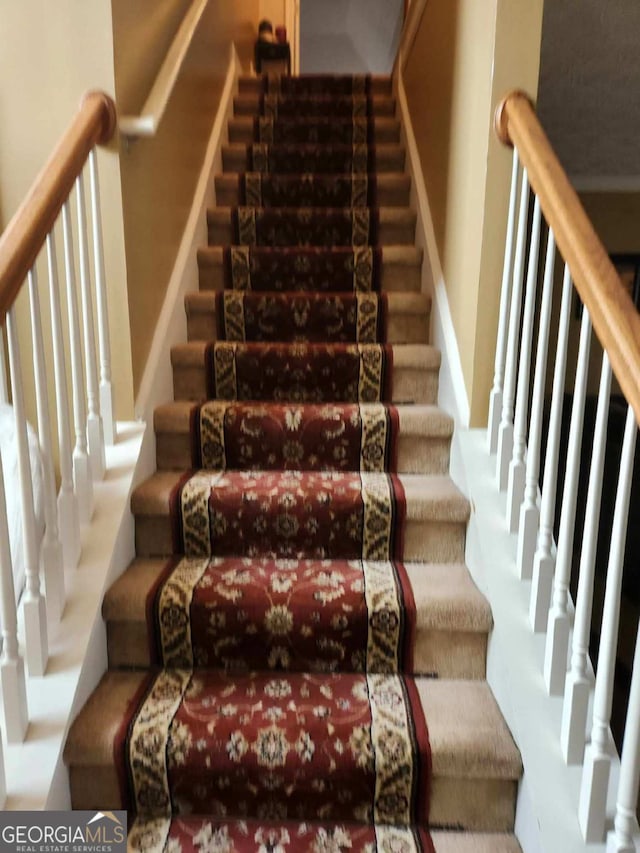 stairs featuring carpet