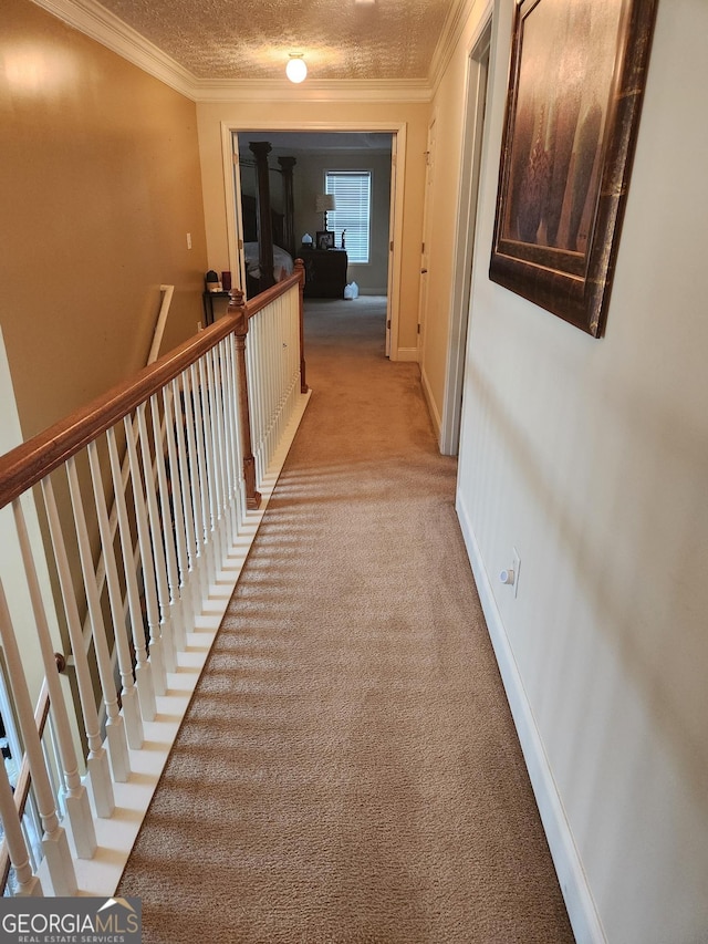 corridor with ornamental molding, an upstairs landing, and light carpet