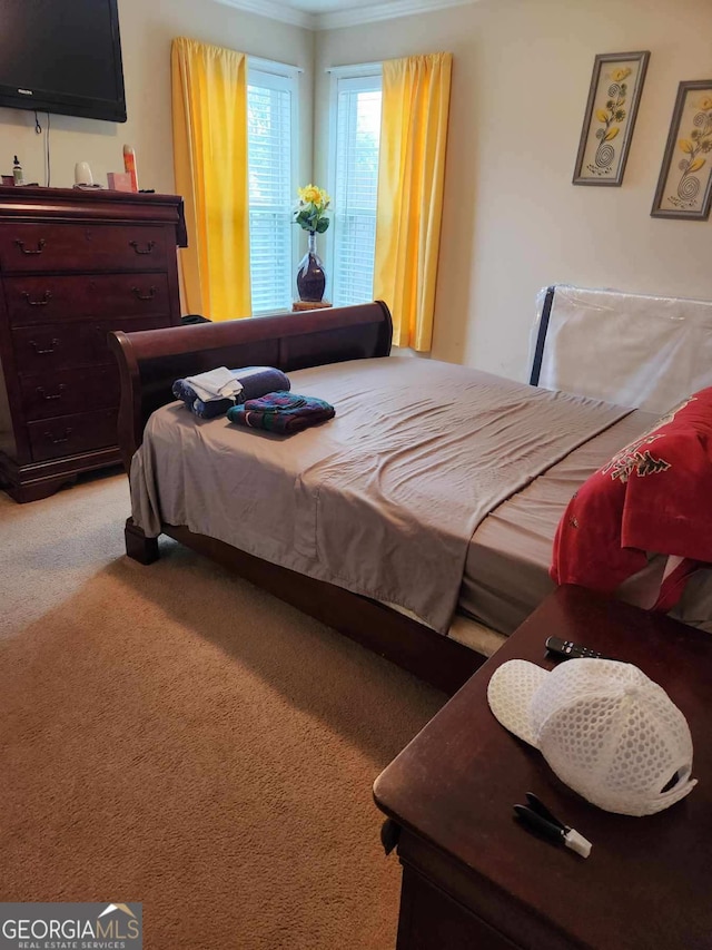 carpeted bedroom featuring ornamental molding