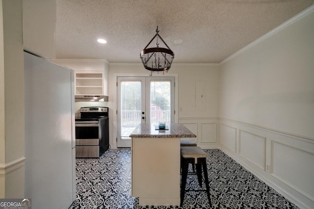 kitchen with ornamental molding, a kitchen island, exhaust hood, a breakfast bar, and stainless steel electric stove