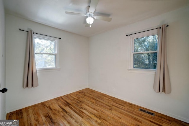 spare room with ceiling fan and light wood-type flooring