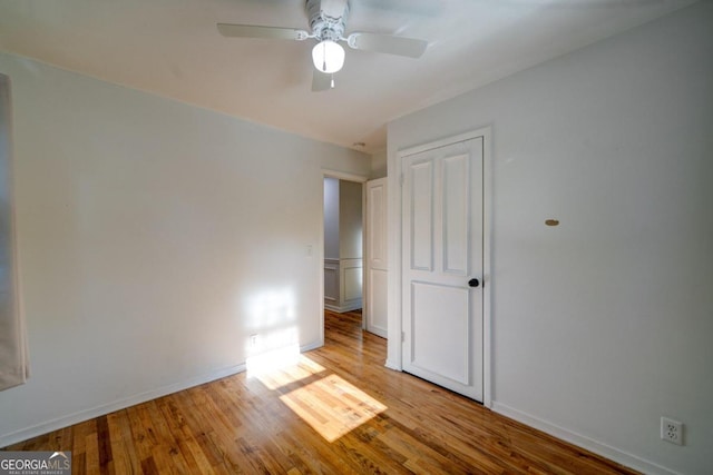 empty room with light wood-type flooring and ceiling fan