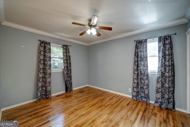 empty room featuring ceiling fan, light wood-type flooring, and ornamental molding