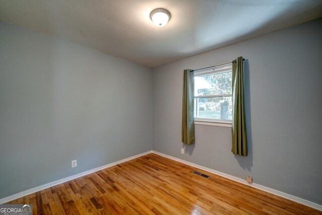 spare room featuring light hardwood / wood-style flooring