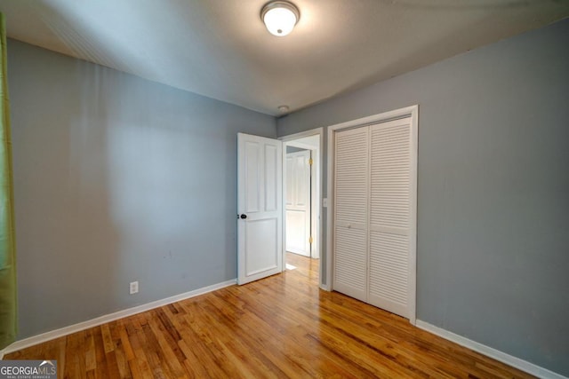 unfurnished bedroom featuring light wood-type flooring and a closet