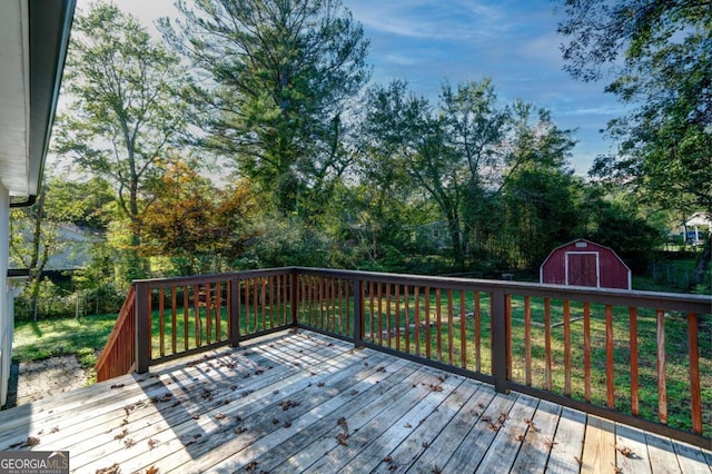 deck featuring a storage shed and a yard