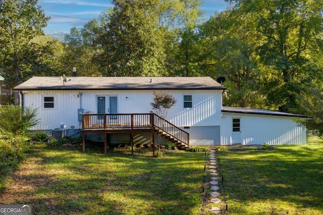 rear view of property featuring a deck and a yard