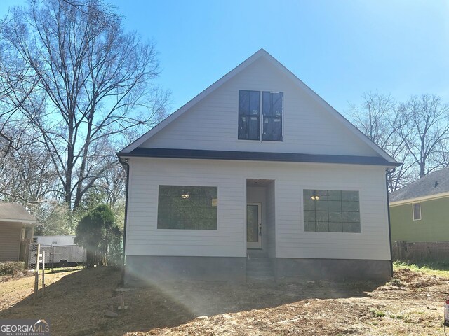 rear view of property featuring a yard