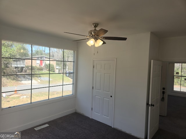 unfurnished bedroom with carpet flooring, visible vents, and a ceiling fan