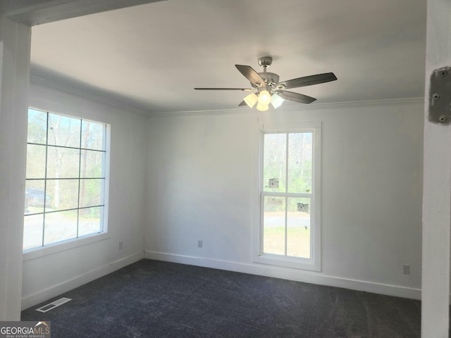 unfurnished room featuring baseboards, visible vents, dark carpet, and ornamental molding