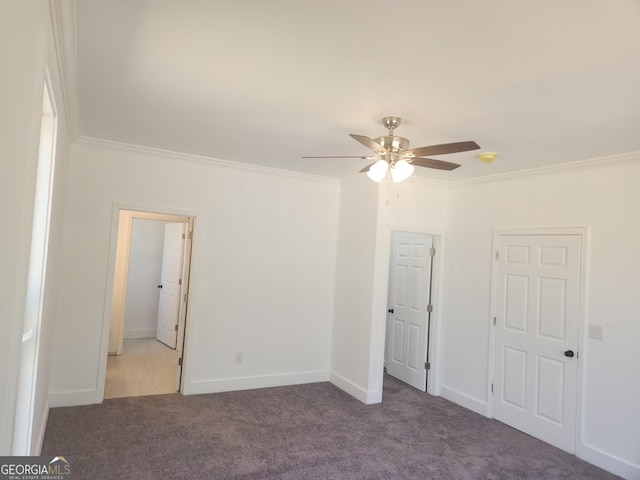 unfurnished bedroom featuring a ceiling fan, carpet, ornamental molding, and baseboards