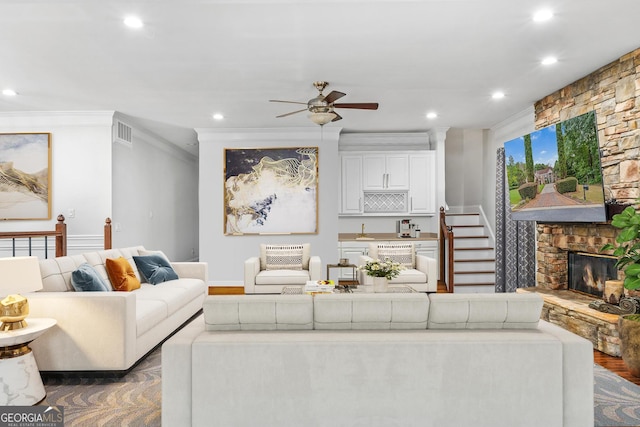 living room featuring a fireplace, ceiling fan, ornamental molding, dark hardwood / wood-style floors, and sink