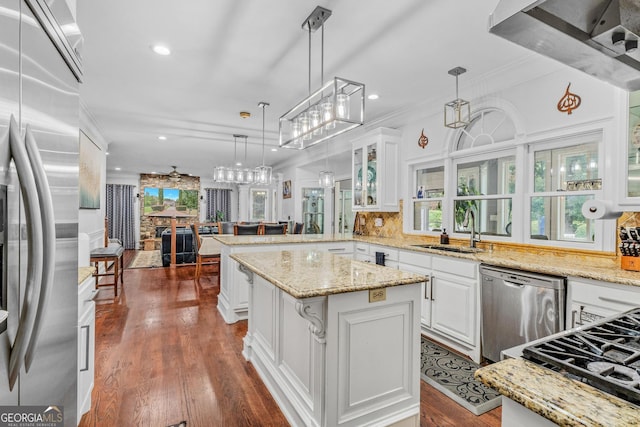 kitchen featuring dark hardwood / wood-style floors, sink, white cabinetry, hanging light fixtures, and stainless steel appliances