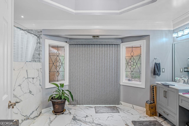 bathroom with ornamental molding, vanity, tile walls, and a wealth of natural light