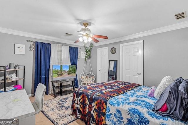 carpeted bedroom featuring ceiling fan and crown molding