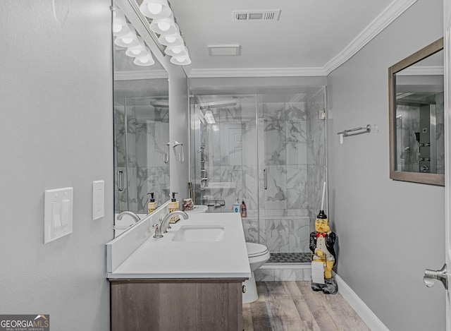 bathroom featuring wood-type flooring, walk in shower, ornamental molding, vanity, and toilet