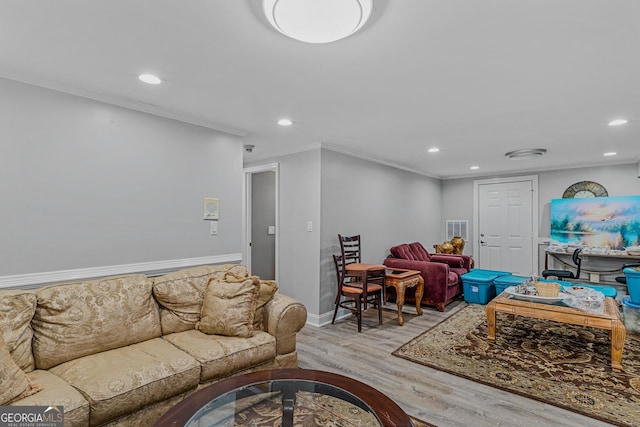 living room featuring light hardwood / wood-style flooring and ornamental molding