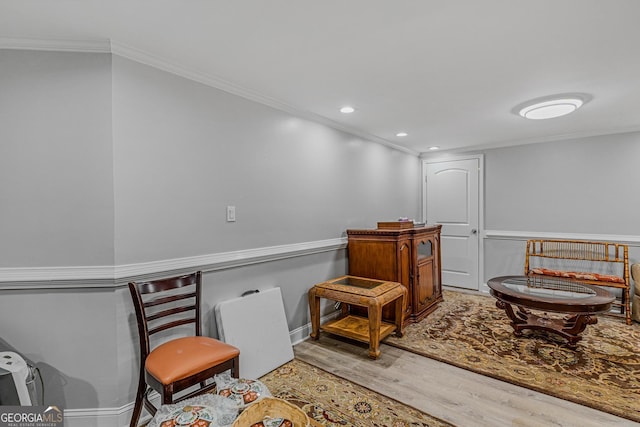 sitting room featuring light hardwood / wood-style flooring and crown molding