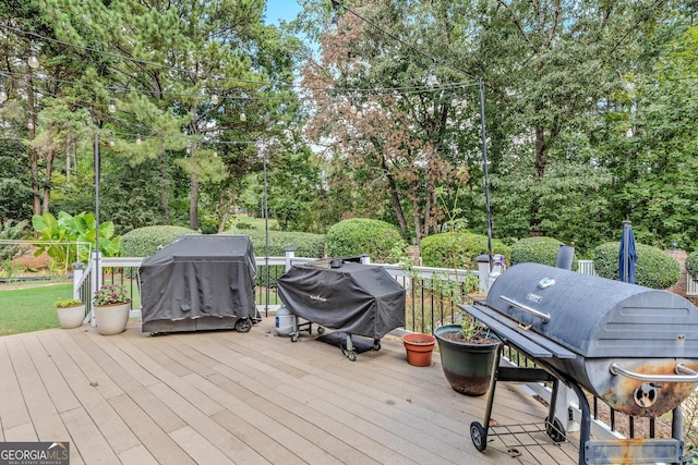 wooden terrace with a grill