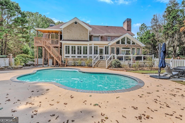 back of property featuring a patio and a swimming pool side deck