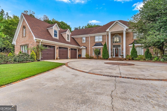 view of front of property with a garage and a front lawn