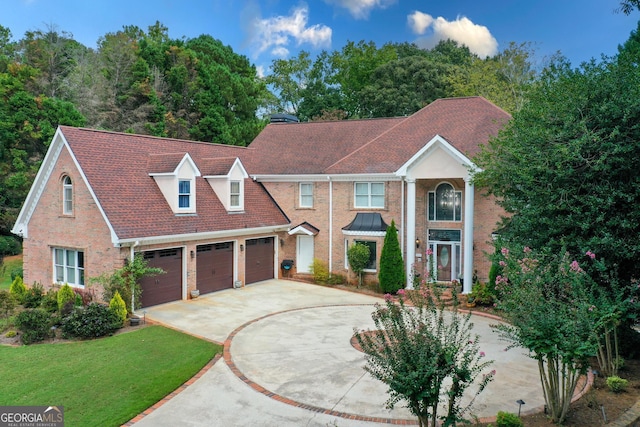 view of front of home with a front yard and a garage